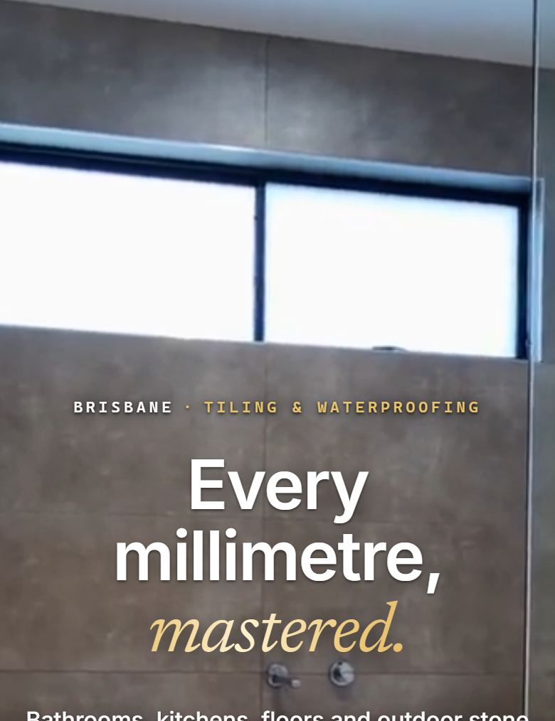 The second tiling build: a full bleed video of a finished bathroom running behind the whole hero, with the headline centred over it in white and gold.